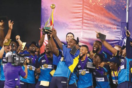 Members of the Barbados Tridents led by their captain Jason Holder lift the winners trophy after capturing the Hero CPL title against the Guyana Amazon Warriors at the Brian Lara Cricket Academy in Tarouba, San Fernando in October, 2019.
