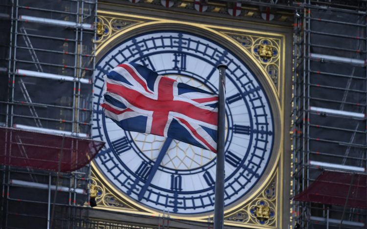 The Union flag flutters near the clock face of Big Ben during ongoing renovations to the Tower and the Houses of Parliament, in central London. (Photo: AP)