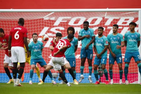 Manchester United’s Bruno fernandes scores the team’s fifth goal from a free kick as Bournemouth players form a wall. (Reuters photo)
