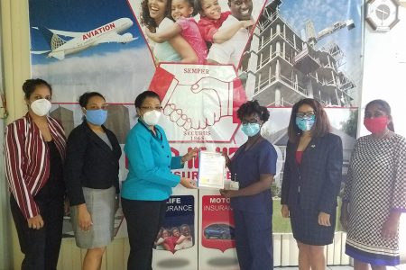 From left to right are:  HiH’s Business Development Officer Savita Singh, HiH’s Assistant Life Manager Elizabeth Gopie, Zaida Joaquin, Dr. Melissa Rickett, Rohmena Chung, and HiH’s Deputy Life Manager Lalita Sukhram. (Hand in Hand photo) 
