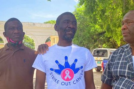 Mentally challenged farmer of St Elizabeth, Abraham Lawrence (second left) and his brothers outside the Black River Parish Court yesterday, where he was offered $10,000 bail.