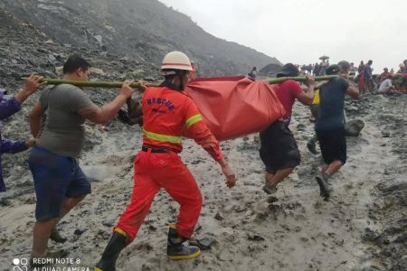 Rescue workers carry a dead body following a landslide at a mining site in Phakant, Kachin State City, Myanmar July 2, 2020, in this picture obtained from social media. MYANMAR FIRE SERVICES DEPARTMENT/via REUTERS