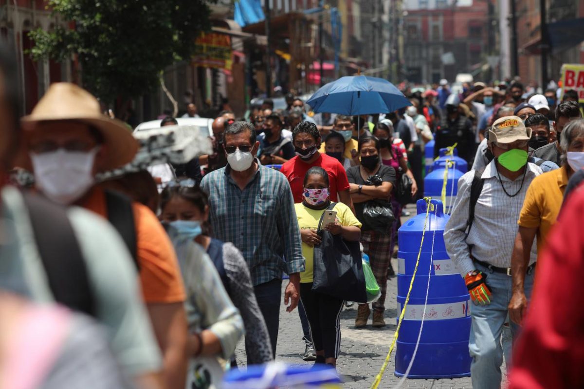 People wait in line along the street before entering the area where stores are open, during the gradual reopening of commercial activities in the city, as the coronavirus disease (COVID-19) outbreak continues, in Mexico City, Mexico July 6, 2020. REUTERS/Henry Romero