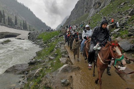 Hindu pilgrims travel, either on ponies or on foot, along a track besides a glacier-fed stream during their annual pilgrimage to holy cave of Lord Shiva, in Pishutop, 114 km (71 miles) southeast of Srinagar June 25, 2012.
Photograph: Fayaz Kabli (Reuters)