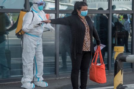 A passenger being sanitised upon entry at CJIA (DPI photo)