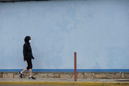 A woman wearing a protective face mask walks during the lockdown amid the spread of the coronavirus disease (COVID-19) in Burela, Spain July 6, 2020. REUTERS/Miguel Vidal
