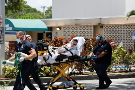 Emergency Medical Technicians (EMT) leave with a patient at Hialeah Hospital where the coronavirus disease (COVID-19) patients are treated, in Hialeah, Florida, U.S., July 29, 2020. REUTERS/Marco Bello
