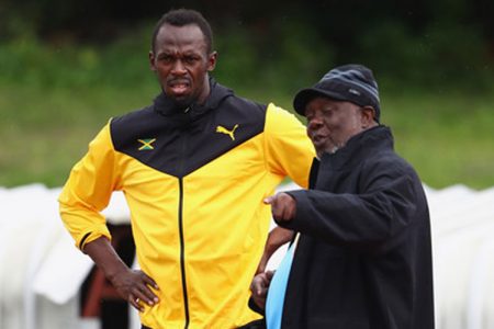 Usain Bolt with Coach Glen Mills