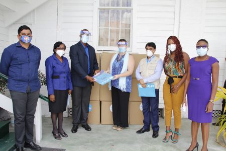 Sylvie Fouet (fourth from right) making the presentation to Alfred King (Ministry of Education photo)
