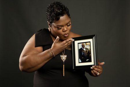 Devon Brumfield holds a photo of her father Darrell Cager Sr., who died on March 31 from complications of the coronavirus disease (COVID-19), in this undated handout image. Devon Brumfield/Handout via REUTERS