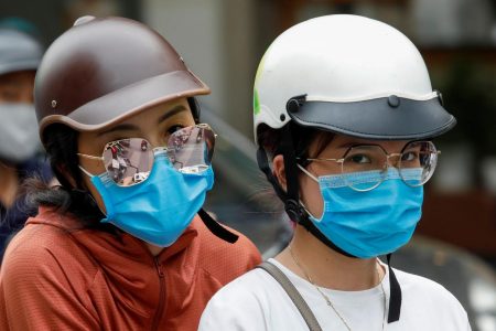 Women wear protective masks as they ride in a street, during the coronavirus disease (COVID-19) outbreak, in Hanoi, Vietnam July 27, 2020. REUTERS/Kham
