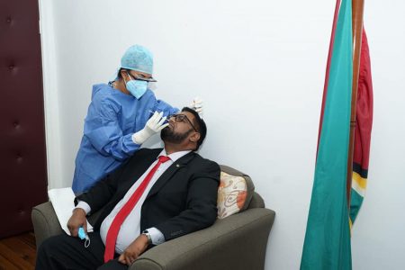 President Irfaan Ali having his sample taken for testing following the announcement on yesterday (Office of the President photo)