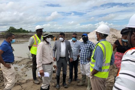 Minister within the Ministry of Public Works, Deodat Indar (centre) with his team during the tour on Friday.