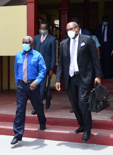 Clairmont Mingo (left) and Attorney Nigel Hughes leaving the court yesterday.