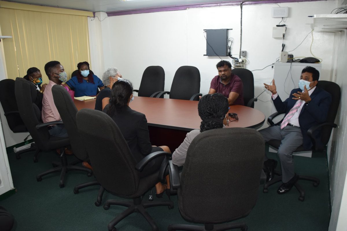 Minister of Legal Affairs Anil Nandlall (right) speaking to the programme staff (Ministry of Legal Affairs photo)