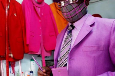 Kenyan fashionista James Maina Mwangi during a Reuters interview where he displayed his attire, comprising at least 160 suits with matching accessories, including a mask, to prevent the coronavirus disease (COVID-19) infection at his residence in Nairobi, Kenya July 30, 2020. (REUTERS/Thomas Mukoya photo)