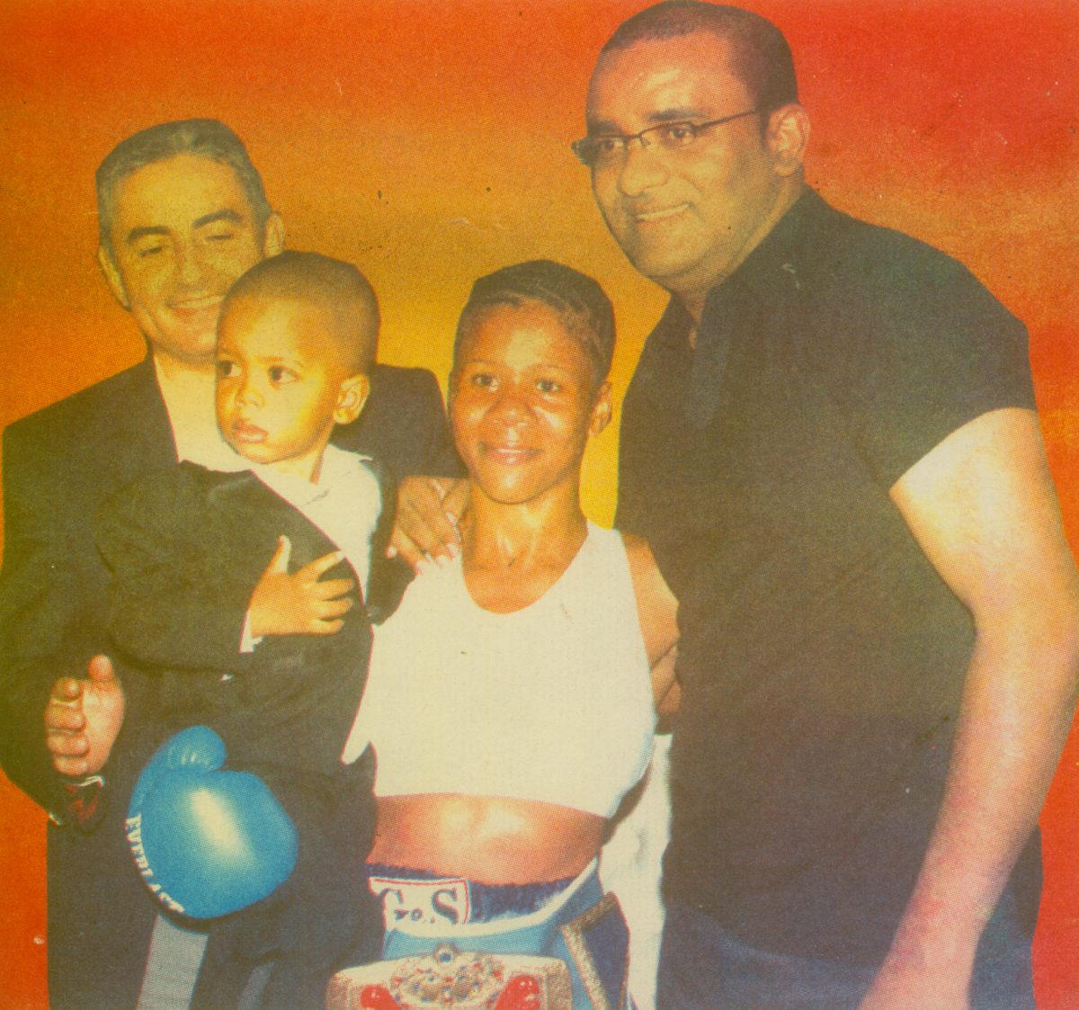 Shondell Alfred with her son, then President of Guyana Bharrat Jagdeo and Muharam Kulekei, General Manager of Princess Hotel, following her successful title defence against Corinne De Groot in 2010.
