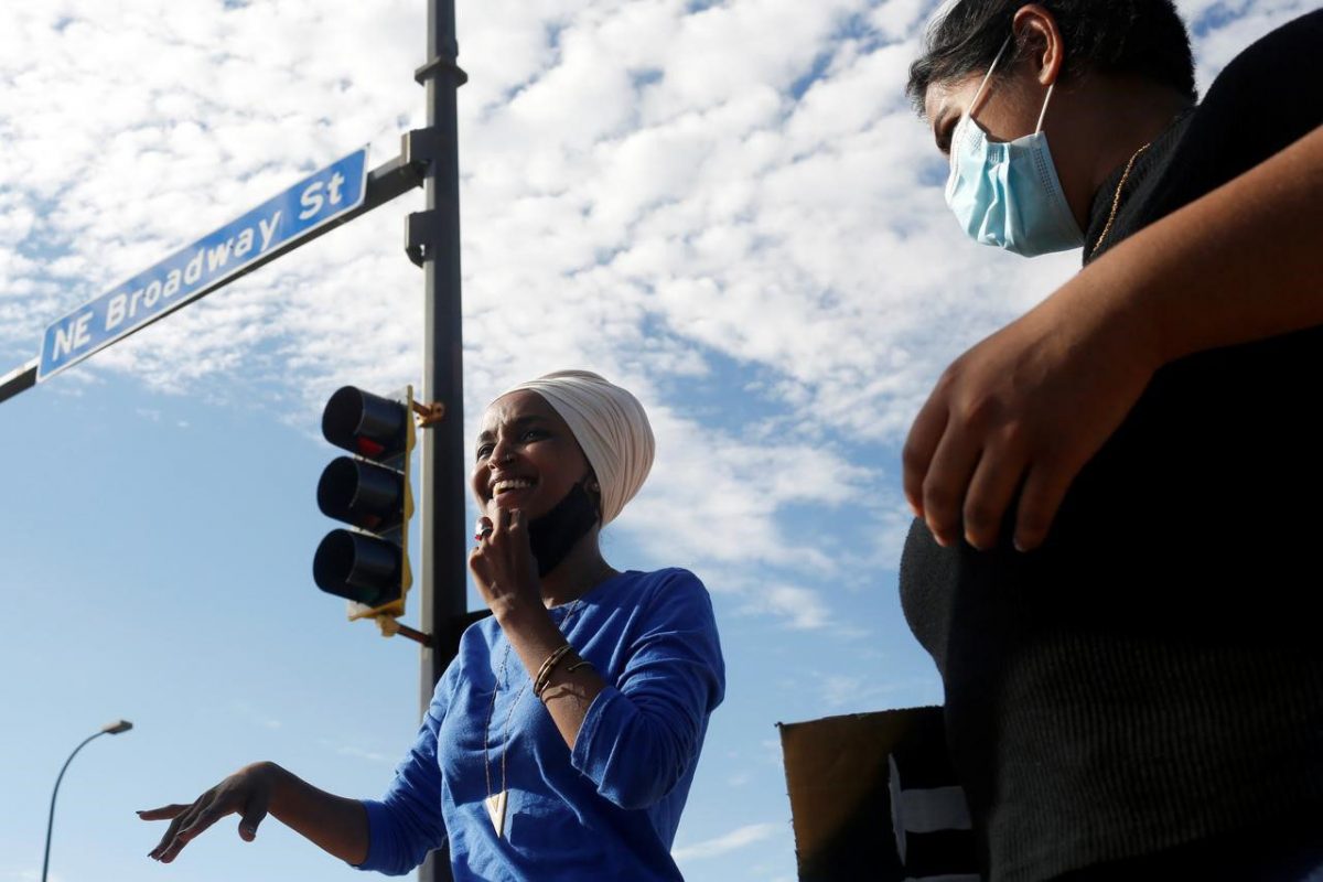 Representative Ilhan Omar waves to cars and stands with volunteers and campaign members in northeast Minneapolis for a "Get Out The Vote" event during the primary election in Minneapolis, Minnesota, U.S. August 11, 2020. REUTERS/Nicole Neri
