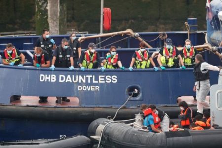 Migrants prepare to disembark at Dover harbour, in Dover