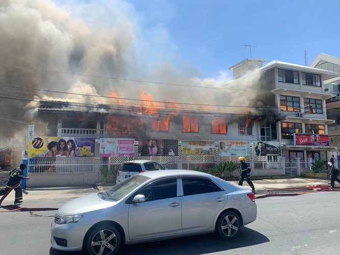 An early phase of yesterday’s fire on Sheriff Street showing firemen scrambling to begin fighting the blaze.