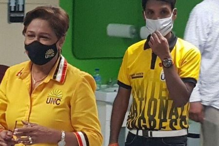 ‘FIGHT NOT OVER’: United National Congress political leader Kamla Persad-Bissessar arrives at her Siparia constituency office last night with Princes Town MP Barry Padarath. 