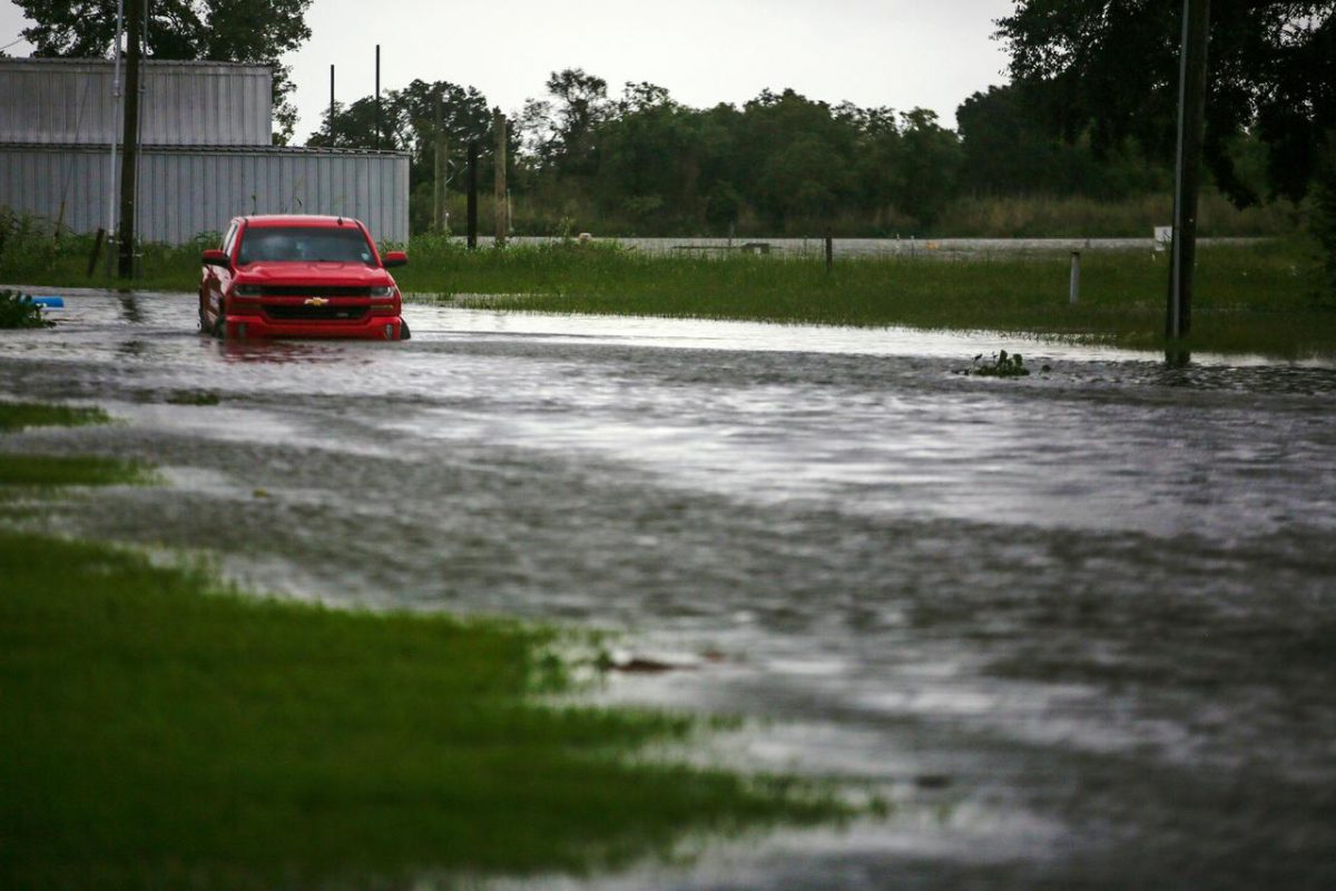 A car near Vermilion Bay is seen partially submerged in waters brought by Hurricane Laura approaching Abbeville, Louisiana, U.S., August 26, 2020. REUTERS/Kathleen Flynn