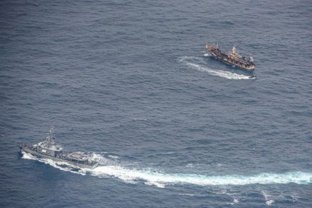 Ecuadorian Navy vessels surround a fishing boat after detecting a fishing fleet of mostly Chinese-flagged ships in an international corridor that borders the Galapagos Islands' exclusive economic zone, in the Pacific Ocean, August 7, 2020. REUTERS/Santiago Arcos