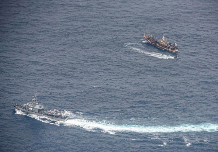 Ecuadorian Navy vessels surround a fishing boat after detecting a fishing fleet of mostly Chinese-flagged ships in an international corridor that borders the Galapagos Islands' exclusive economic zone, in the Pacific Ocean, August 7, 2020. REUTERS/Santiago Arcos