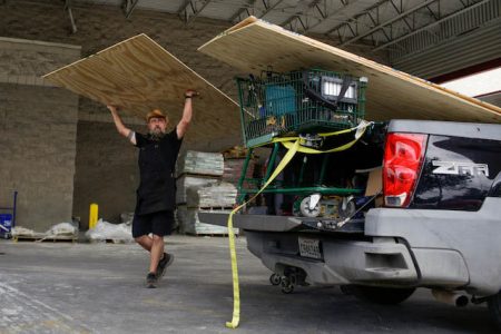 Paul Humphrey, of New Orleans, loads plywood into his truck, to board a friend’s home in preparation for the arrival of hurricanes Marco and Laura, which are forecasted to move onshore Monday and Thursday, at Lowe’s in New Orleans, Louisiana, US, on Aug. 23, 2020 (Reuters/Kathleen Flynn)