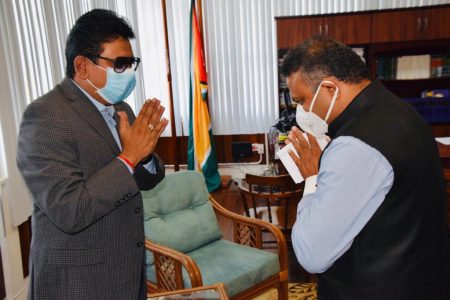 Indian High Commissioner to Guyana Dr K.J Srinivasa (right) greeting Attorney General Anil Nandlall.