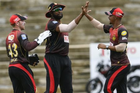 Trinbago Knight Riders skipper Kieron Pollard, centre and Lendl Simmons celebrate at the fall of a wicket. (Photo courtesy CPL)