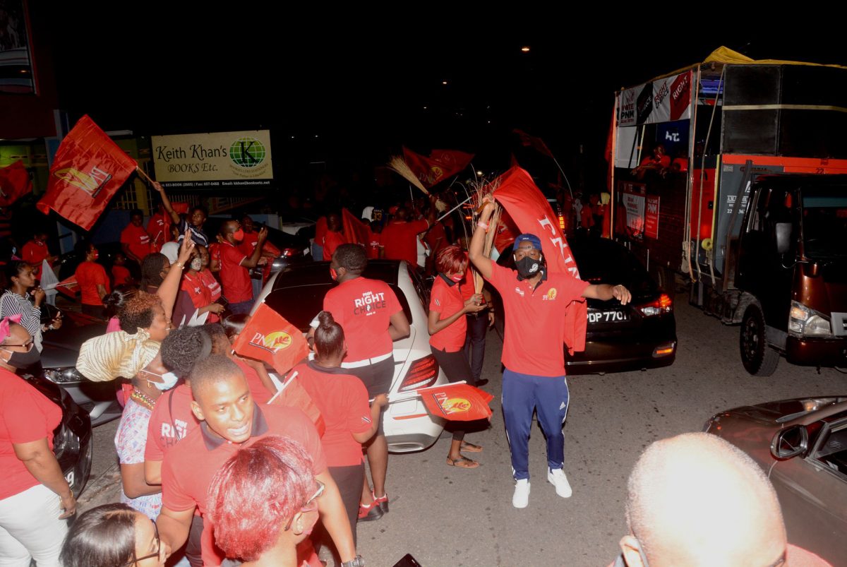 PNM supporters celebrate San Fernando East candidate Brian Manning’s victory on Navet Street, San Fernando on Monday night.
