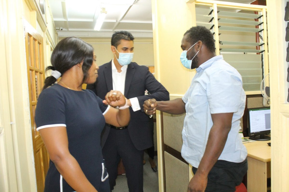 Getting to grips with the job: Minister of Sport, Charles Ramson (Jr) (centre) meeting staffers yesterday at his ministry. (Ministry of Culture, Youth and Sport photo)