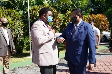 President Irfaan Ali (left) and Suriname’s President Chandrikapersad Santokhi greeting each other today at State House. (Office of the President photo)