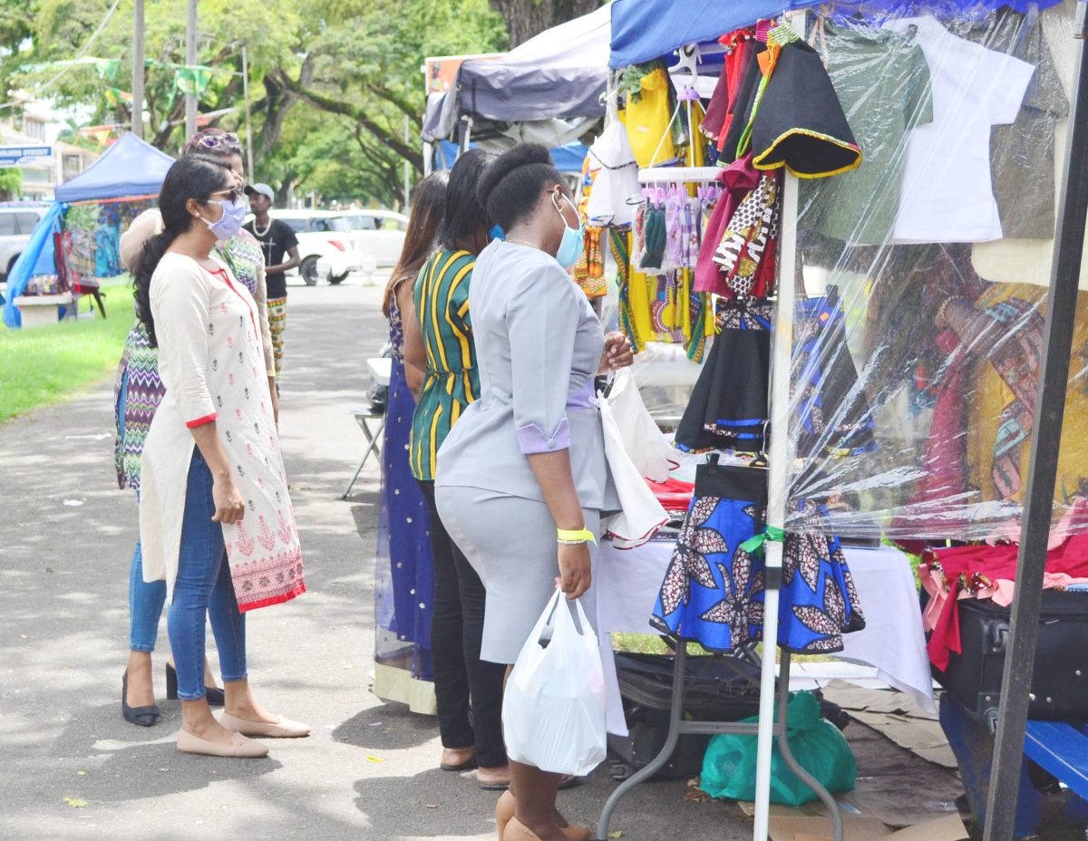 Persons shopping last Wednesday along the Main Street avenue, where some vendors showcased attire and craft for Emancipation celebrations (Photo by Orlando Charles)  