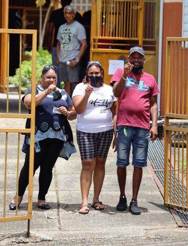 This family of three show their fingers after they voted at the St Joseph Government Primary School during last Monday’s General Election. The recount process in that constituency is now holding up the ratification of the final results.