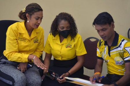Successful United National Congress (UNC) candidates Khadijah Ameen, left, speaks with colleagues Anita Haynes public relations officer for the UNC and incumbent Member of Parliament for Princes Town Barry Padarath, during a media conference at the UNC South Regional Office at M. Rampersad building in San Fernando, on Tuesday afternoon. -Photo: DEXTER PHILIP 
