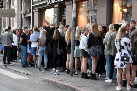 People queue in front of a night club after the coronavirus disease (COVID-19) restrictions for restaurants, bars and nightclubs were lifted, in Helsinki, Finland July 15, 2020. Jussi Nukari/Lehtikuva /via REUTERS