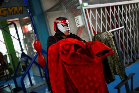 Mexican wrestler Octagon holds his cloak before an interview with Reuters. (Reuters photo)