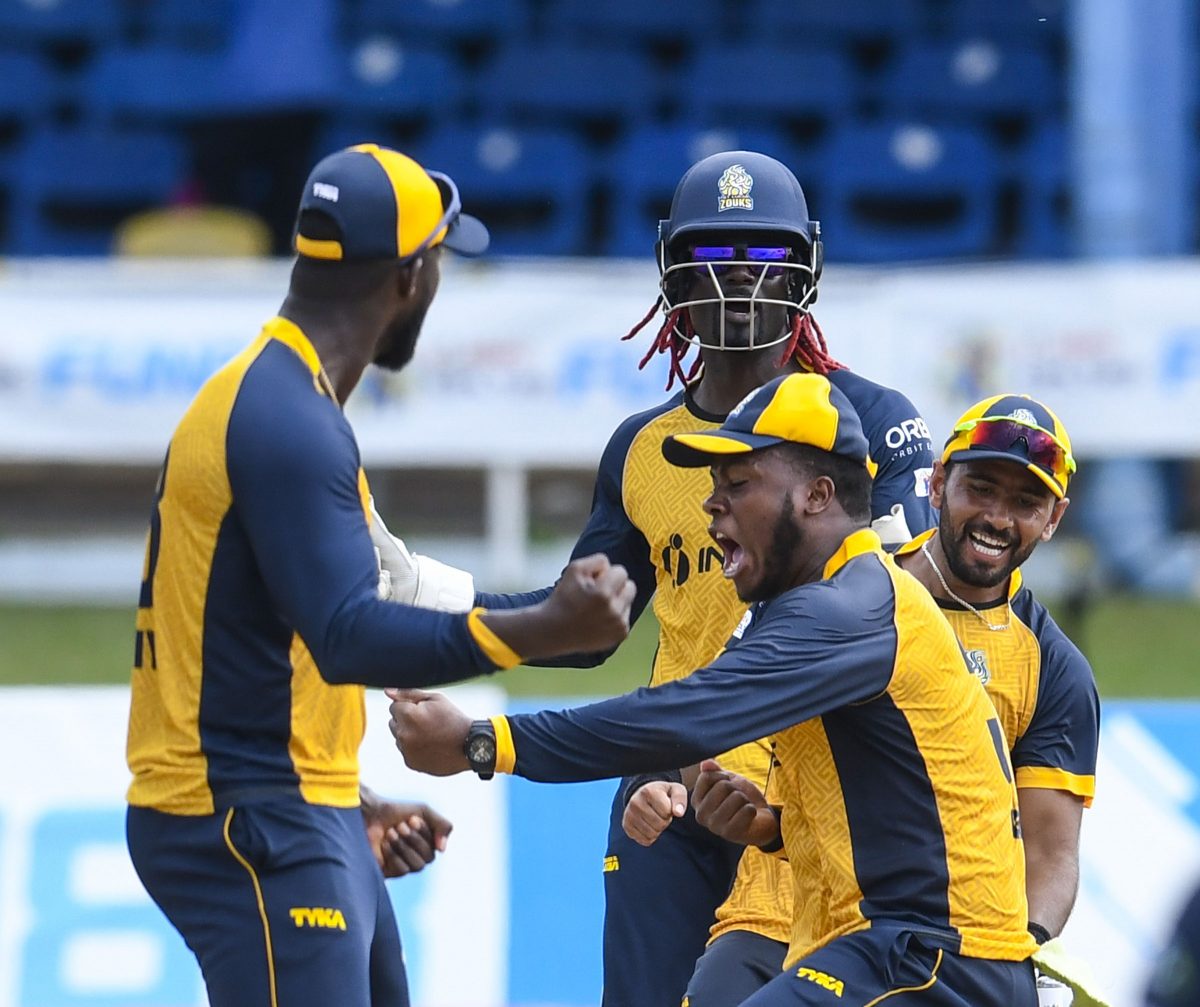St Lucia Zouks’s Javelle Glen, second right, Najibulla Zadran, right and Andre Fletcher celebrate their team’s victory against the Barbados Tridents yesterday. (Photo by Randy Brooks –CPLT20 via Getty Images)