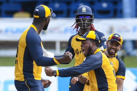 St Lucia Zouks’s Javelle Glen, second right, Najibulla Zadran, right and Andre Fletcher celebrate their team’s victory against the Barbados Tridents yesterday. (Photo by Randy Brooks –CPLT20 via Getty Images)