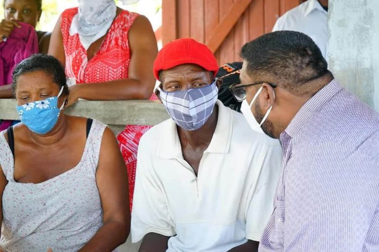 President Irfaan Ali meeting with relatives of the two teenage cousins, Isaiah and Joel Henry, who were murdered last weekend (Office of the President photo)
