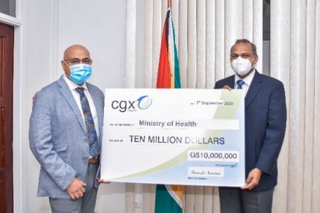The symbolic cheque for $10M being presented to Dr. Frank Anthony (right) by Professor Suresh Narine