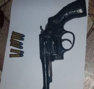The unlicensed firearm and the live rounds that were allegedly found in the suspect’s possession.