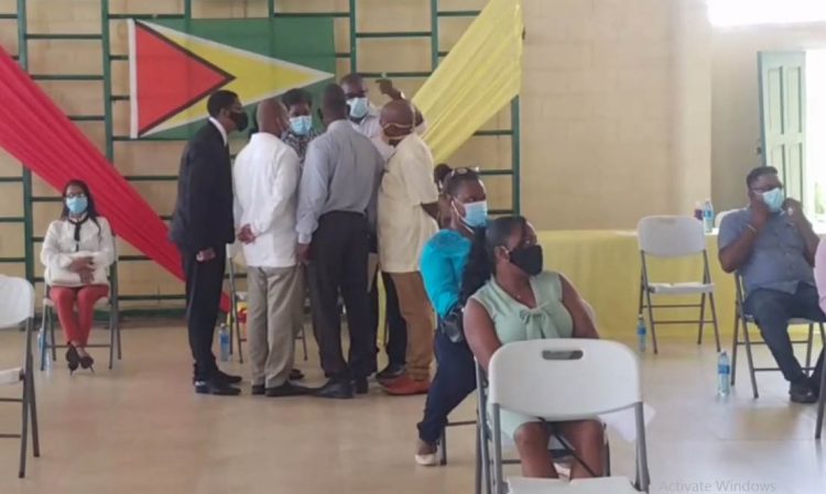 General Secretary of the AFC David Patterson (standing at rear with arm raised) speaks with the AFC nominees before the vote for Chair and Vice Chair of the Region Four RDC.
