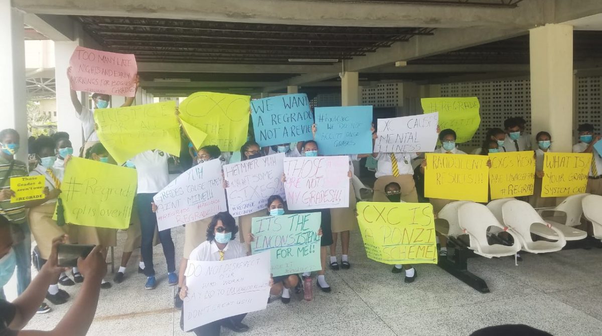 Students of Queen’s College protesting the inconsistent awards by the Caribbean Examinations Council. 

