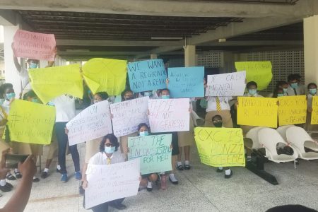 Students of Queen’s College protesting the inconsistent awards by the Caribbean Examinations Council.
