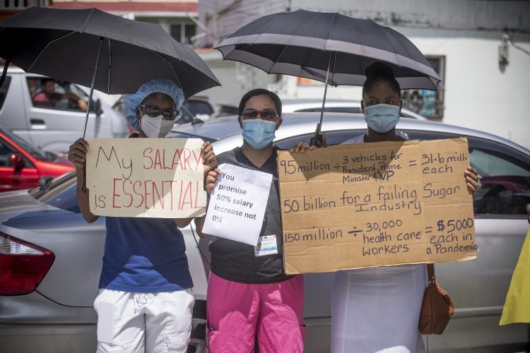 Protesting GPH workers with placards detailing their concerns
