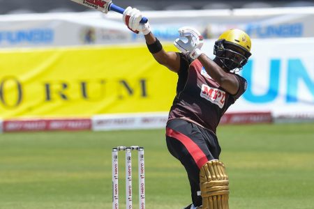 Left-hander Darren Bravo takes one hand off the bat as he hits one of three sixes during his half-century.
