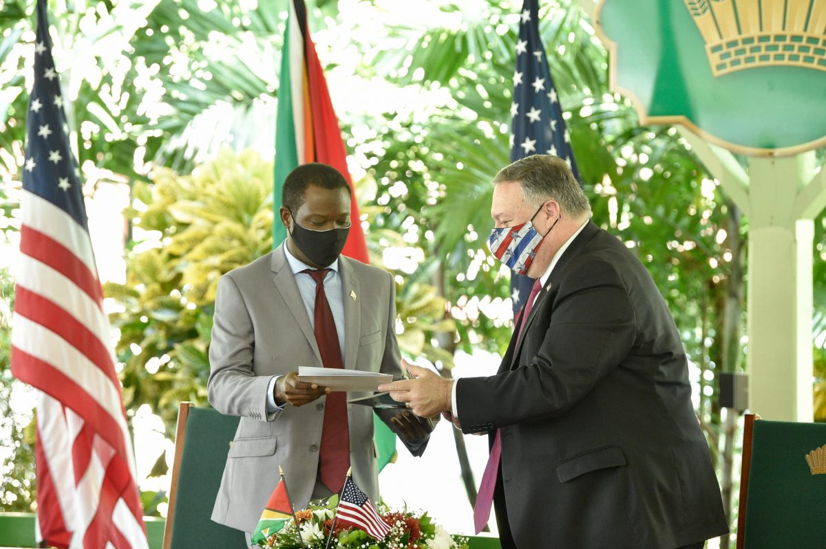 Foreign Minister Hugh Todd (left) and US Secretary of State Mike Pompeo exchanging one of the agreements. (Office of the President photo)